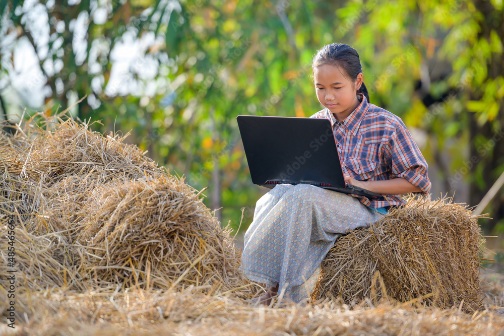 Asian girls living in rural areas and schools in rural Thailand are happy to sit and watch laptops for education and study online using their laptops. Asian girls living in rural areas and schools in rural Thailand are happy to sit and watch laptops for education and study online using their laptops.
