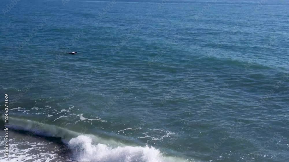 A person swimming in the ocean with snorkeling equipment. High waves crashing in on the beach in Nerja Spain. A man wearing snorkeling equipment swimming in the sea. A person swimming in the ocean with snorkeling equipment. High waves crashing in on the beach in Nerja Spain. A man wearing snorkeling equipment swimming in the sea.