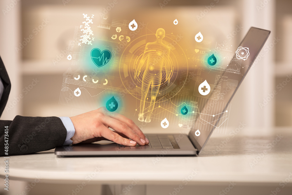 Doctor working on laptop with healthcare concept Doctor working on laptop with healthcare concept