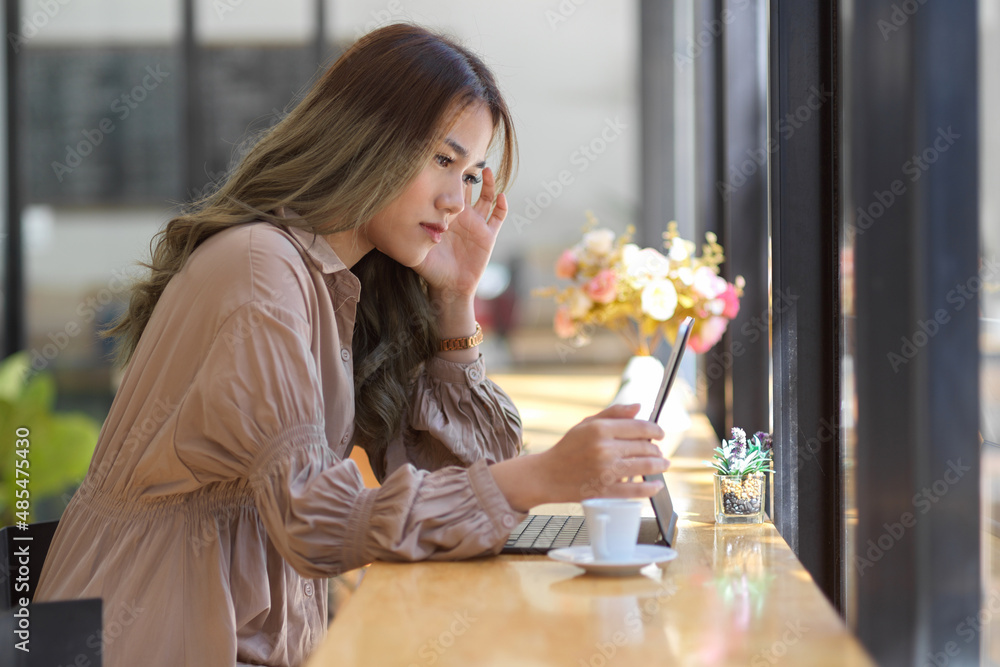 Stressed woman working on portable tablet touchpad Stressed woman working on portable tablet touchpad