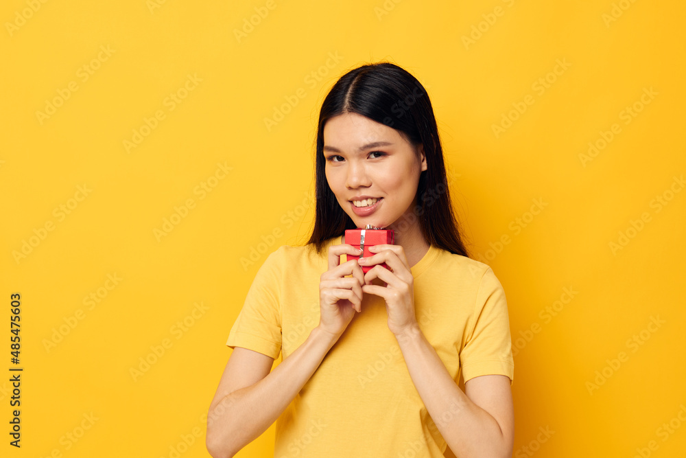 woman with Asian appearance holding a gift box in his hands posing Lifestyle unaltered woman with Asian appearance holding a gift box in his hands posing Lifestyle unaltered