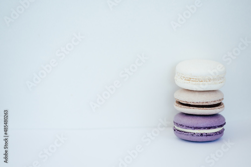Fototapeta Naklejka Na Ścianę i Meble -  purple gray and white macarons on a white background fresh and delicious dessert
