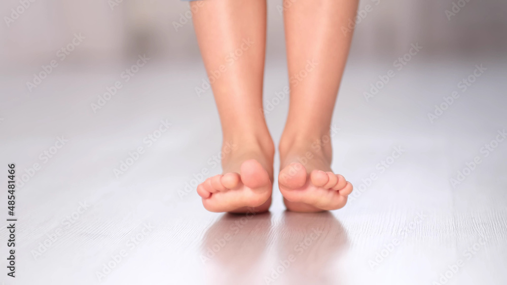 child rolls from heel to toe. Prevention of flat feet in children. Exercises for the legs. Flat feet physical therapy. close up child rolls from heel to toe. Prevention of flat feet in children. Exercises for the legs. Flat feet physical therapy. close up