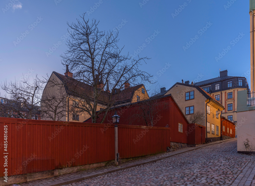 Old 1700s apartment houses with tin roofs and chimneys in the district Södermalm a winter day in Stockholm