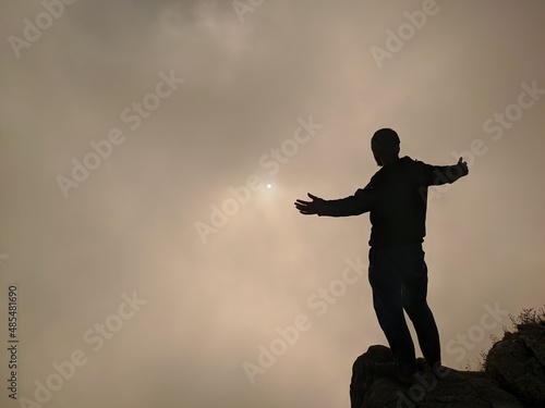 person on top of the clouds