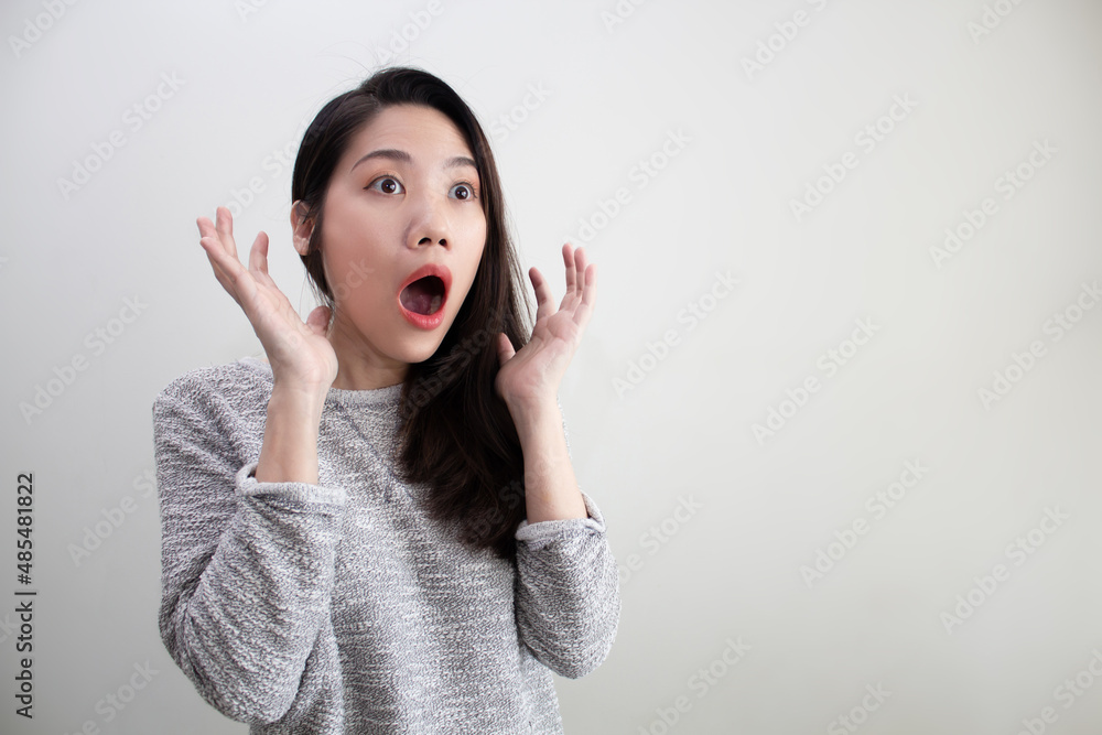 Asian beautiful woman wear green shirt are shocked and surprised with copy space for a promotion and advertisement Asian beautiful woman wear green shirt are shocked and surprised with copy space for a promotion and advertisement