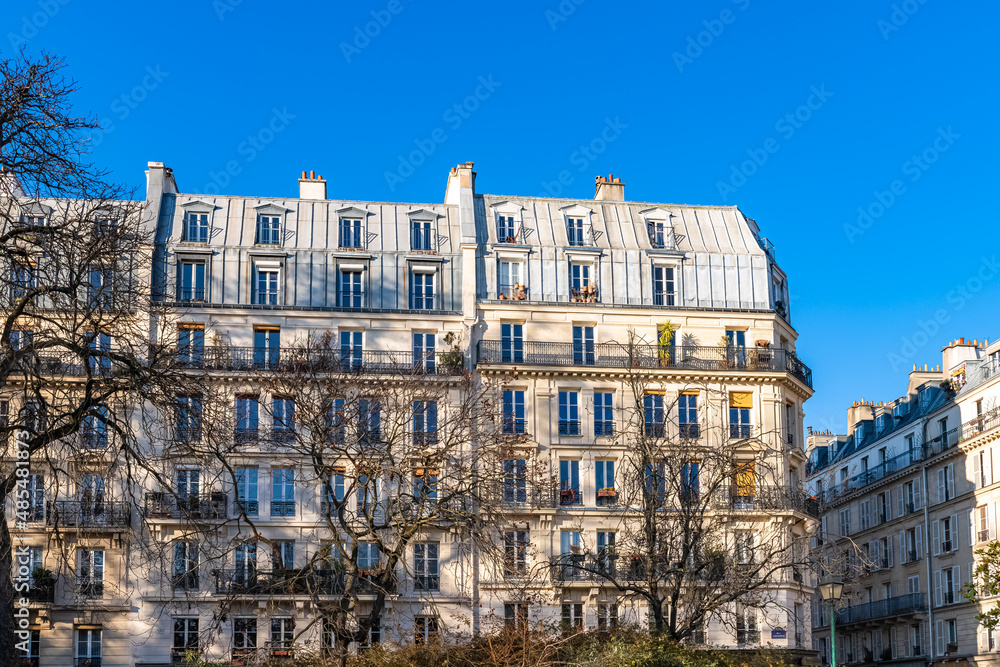 Paris, typical facade, beautiful building, with old zinc roofs rue Saint-Ambroise
