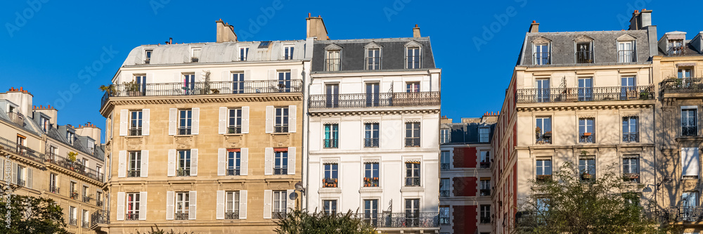 Paris, typical facade, beautiful building, with old zinc roofs rue Saint-Ambroise
