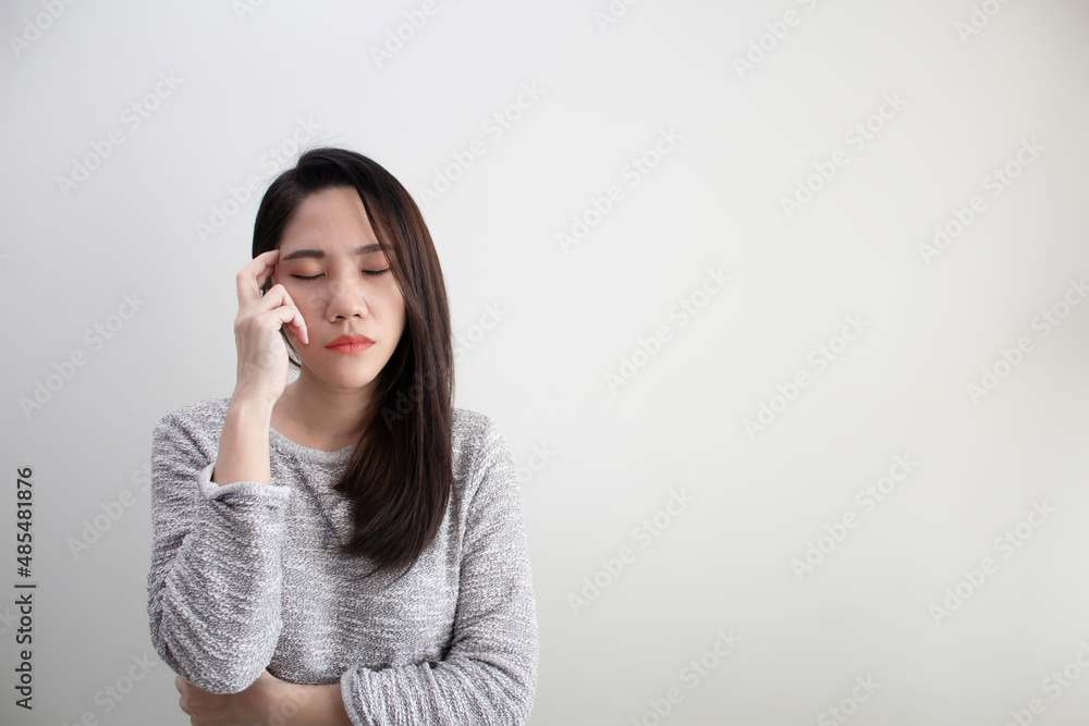 Unhappy Asian beautiful women touch her head with headache, worry and stress. A Healthy life and mental concept. Unhappy Asian beautiful women touch her head with headache, worry and stress. A Healthy life and mental concept.