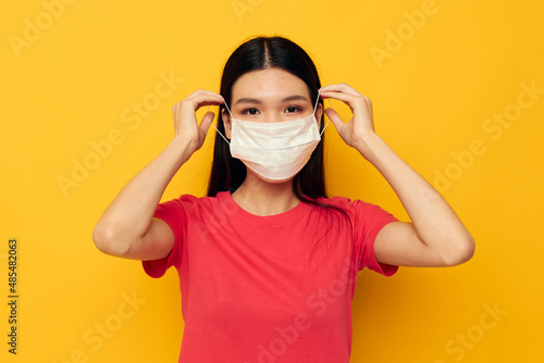 pretty brunette posing medical mask close-up isolated background unaltered