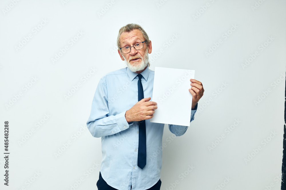 Portrait of happy senior man in a shirt with a tie copy-space sheet of paper cropped view Portrait of happy senior man in a shirt with a tie copy-space sheet of paper cropped view