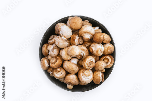 top view of fresh  mushrooms in bowl on white background