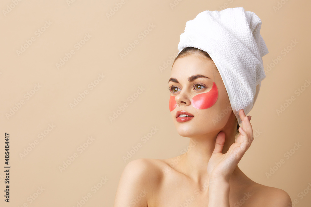 pretty woman with a towel on his head gesturing with his hands skin care close-up Lifestyle