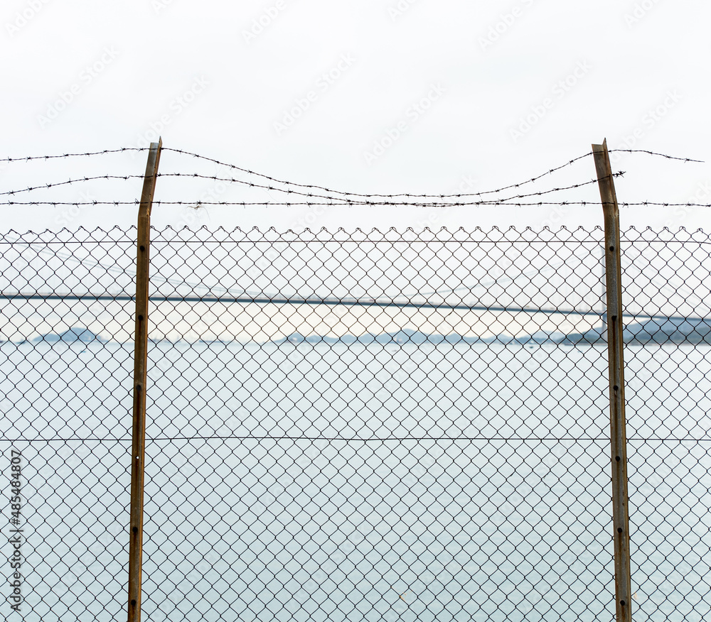 fence with wire in front of the sea fence with wire in front of the sea