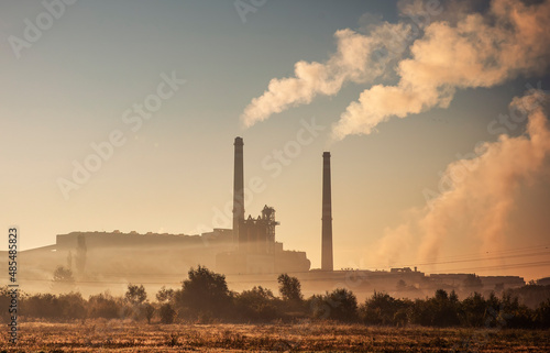 Power station with smoking chimney