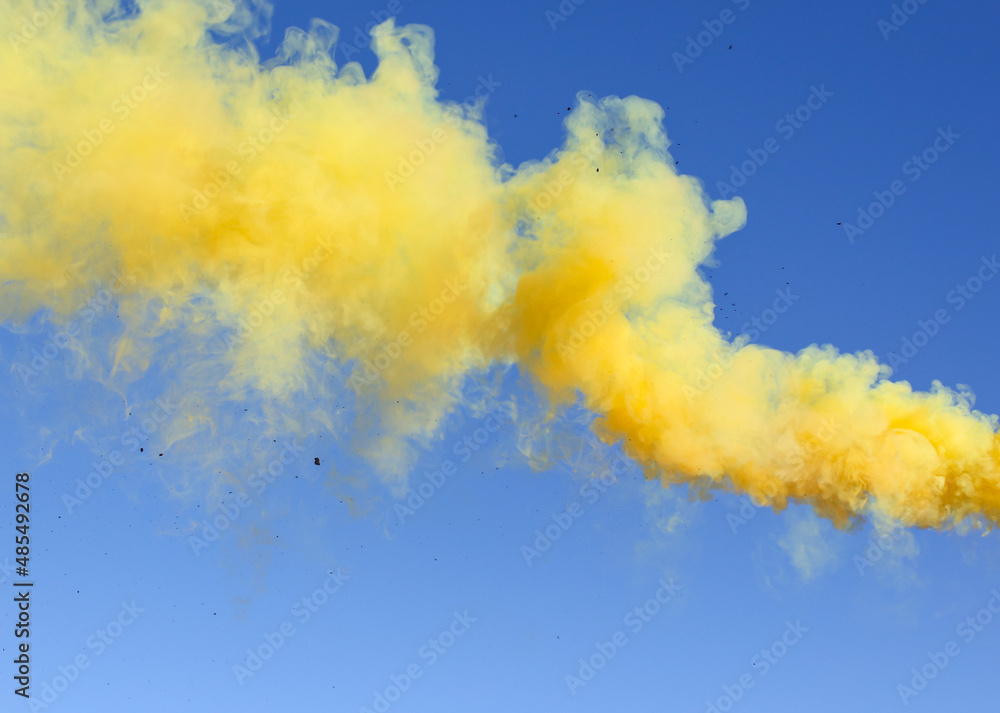 Yellow smoke on a blue background.