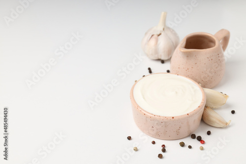 Garlic sauce and ingredients on white background