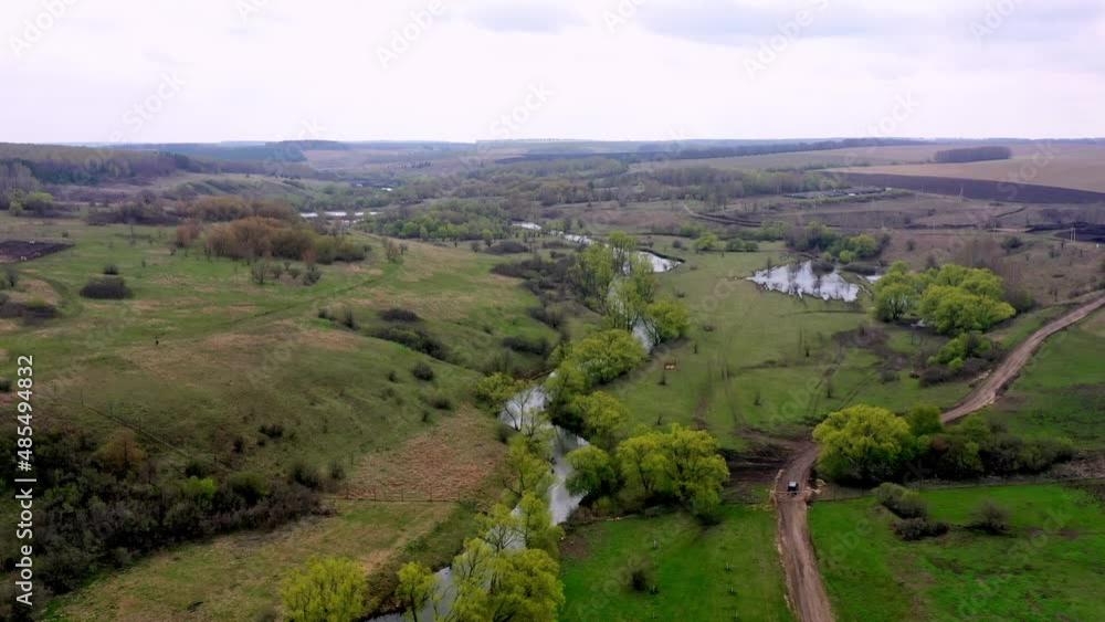 Drone flies over green forest, field, river and pasture in national natural park Drone flies over green forest, field, river and pasture in national natural park