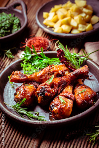 Marinated chicken drumsticks with baked potatoes and spinach