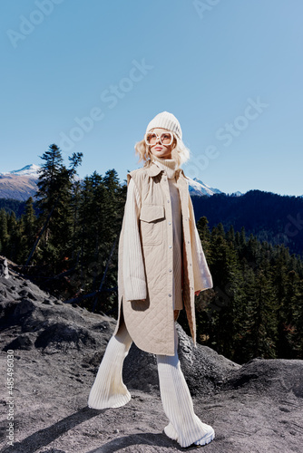 woman standing on the top of the mountain forest lifestyle