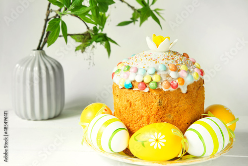 Easter cake with painted eggs on a platter in a gray interior. Traditional festive food photo