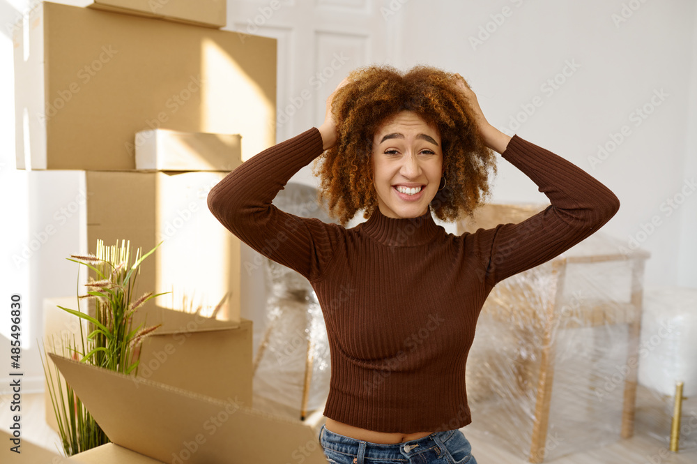 Happy but quite exhausted woman moving home Happy but quite exhausted woman moving home