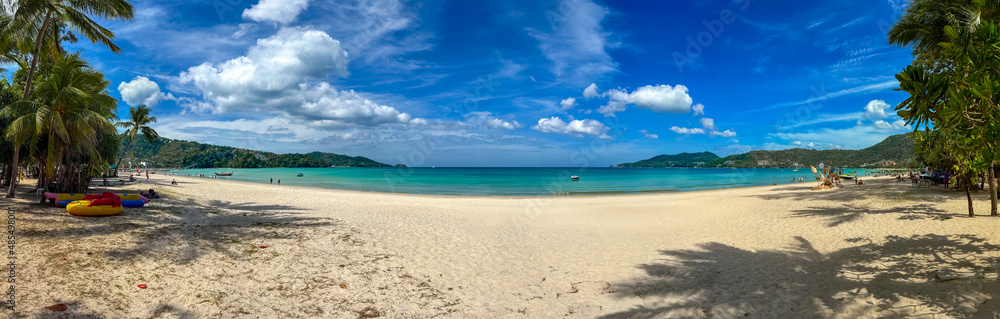 Blue Skies white Sandy Beach and turquoise waters of Patong Beach Phuket Thailand Blue Skies white Sandy Beach and turquoise waters of Patong Beach Phuket Thailand
