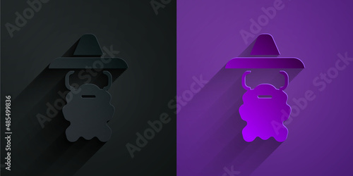 Paper cut Wizard warlock icon isolated on black on purple background. Paper art style. Vector