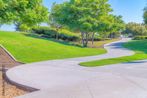 Concrete curvewd pathway in a clean park at San Diego, California