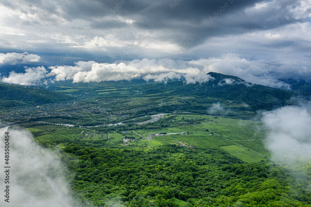 The Caucasus Mountains. Adygeya. The valley of the Belaya River. Low cloud cover. Aerial view.