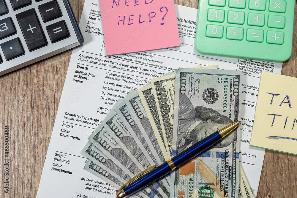 Obraz premium w4, w9 tax form is empty to fill with money dollars on the table.