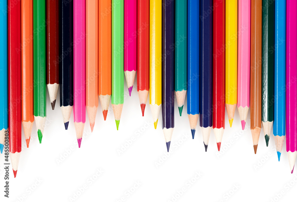 Wooden colored pencils isolated on a white background. A line of multicolored pencils in a large plan Wooden colored pencils isolated on a white background. A line of multicolored pencils in a large plan