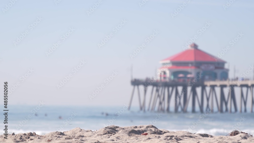 Retro huntington pier, surfing in ocean waves and sandy beach, California coast near Los Angeles, USA. American diner, sea water, beachfront boardwalk, summer vacations. Seamless looped cinemagraph.