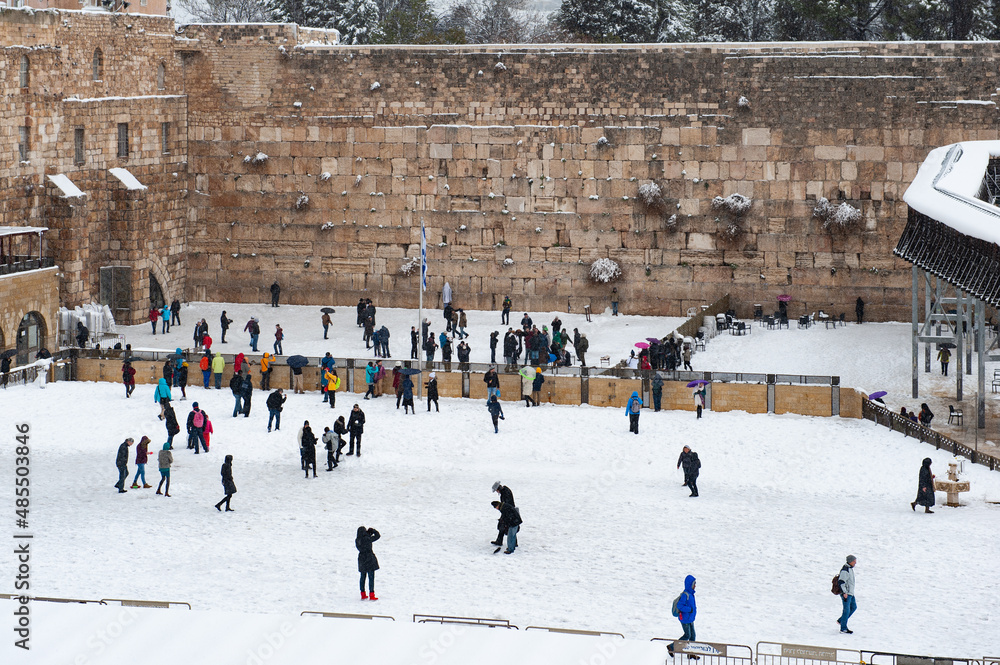 Fototapeta premium A rare winter snow storm adds a white blanket to the Western Wall plaza in Jerusalem. 