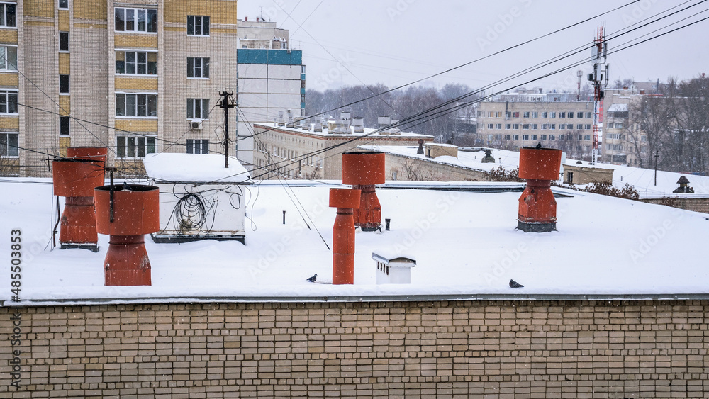 Naklejka premium Ventilation pipes on the roof of an apartment building