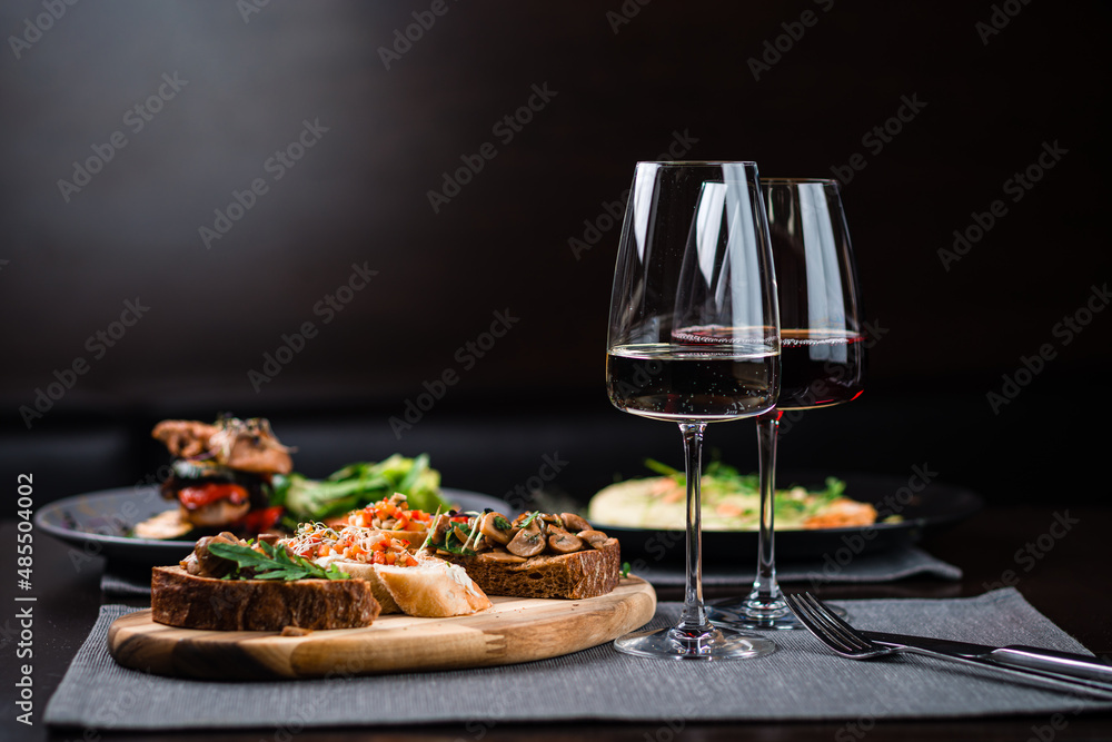 assorted set of bruschetta with salmon with herbs and tuna on black menu background