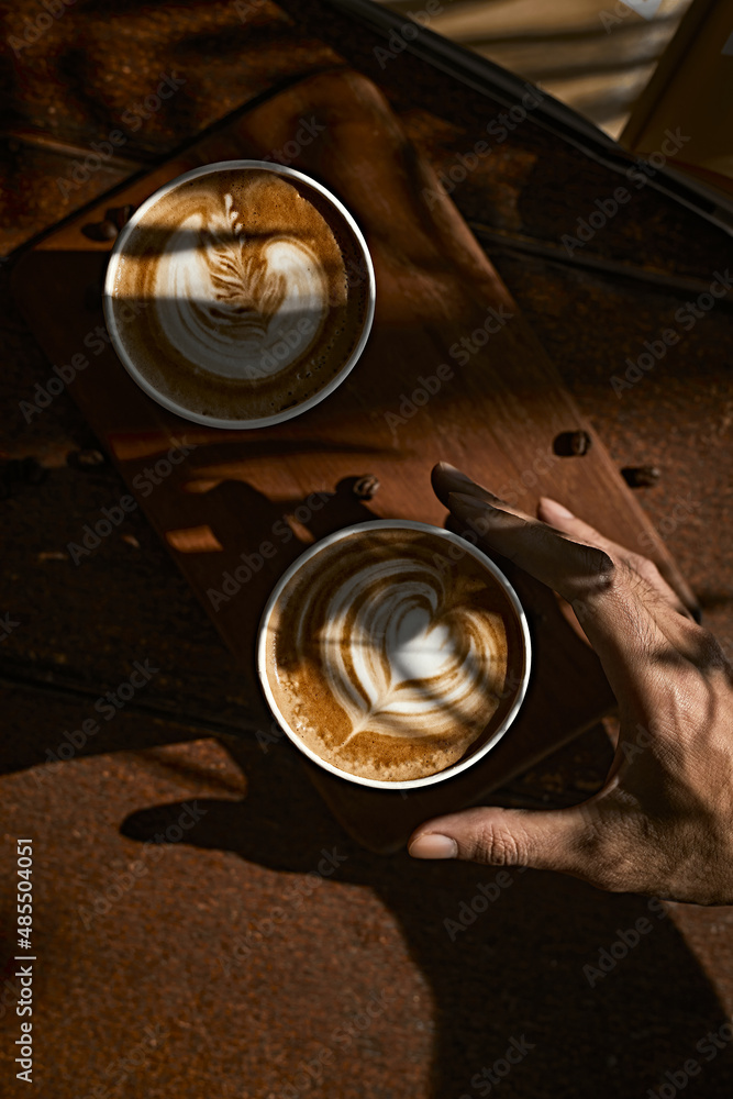 Man holding coffee cup with latte art, Man holding coffee cup with latte art,