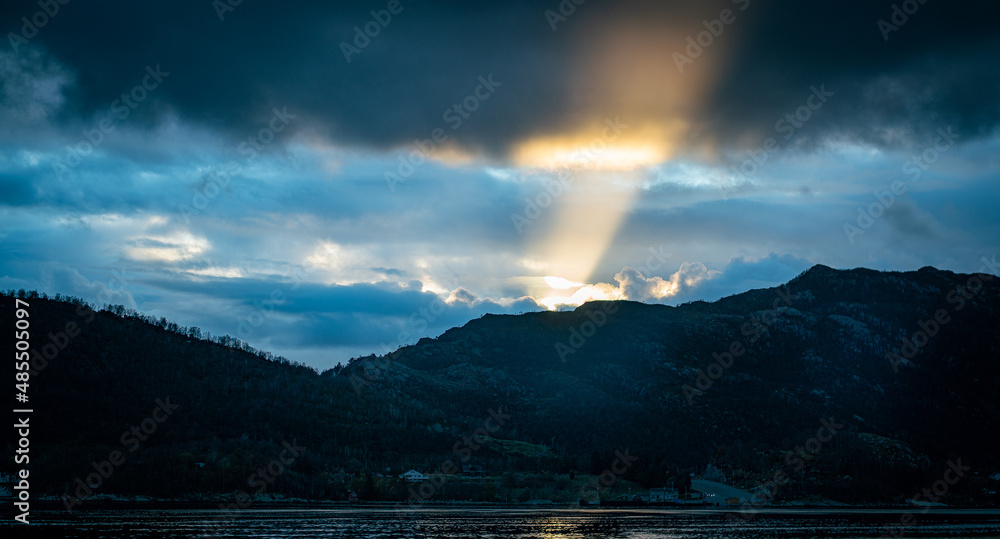 Final rays of sunlight reaching into a fjord in South-Norway