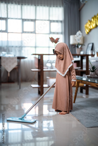 Happy muslim adorable toddler clean the room