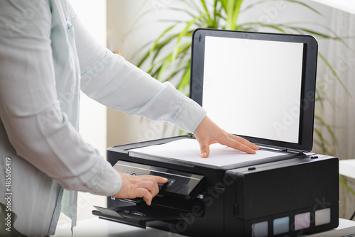 Office work. Secretary woman making a photocopy of important documents. Office manager using printer, scanner or laser copy machine.