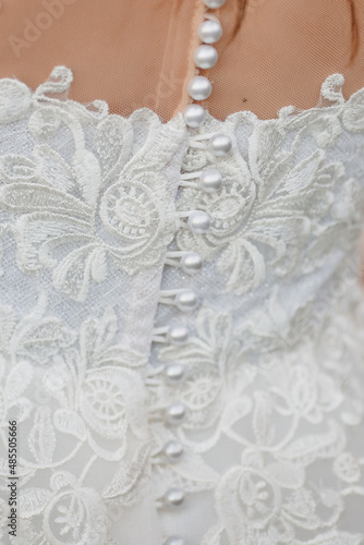 close-up of a wedding dress and pattern. shoulder and back, rear view