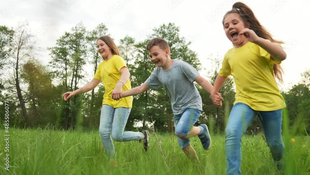 Young team of children. Group of children run in park on grass. Team play in park. Teamwork concept Children run on green grass. Kids team run in park. Kids play in natural park.Group of kids teamwork Young team of children. Group of children run in park on grass. Team play in park. Teamwork concept Children run on green grass. Kids team run in park. Kids play in natural park.Group of kids teamwork