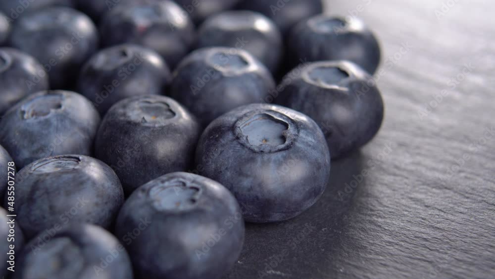 Blueberries on a black kitchen slate stone. Harvest concept. Macro. Rotation Blueberries on a black kitchen slate stone. Harvest concept. Macro. Rotation