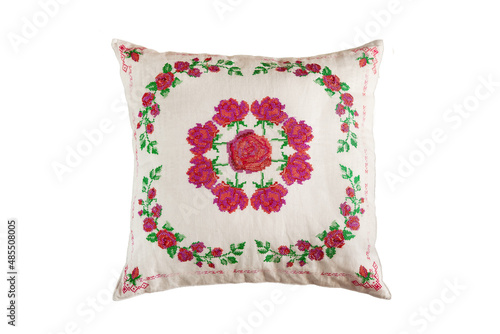 Cross-stitch embroidery in the form of roses on a white linen pillow.