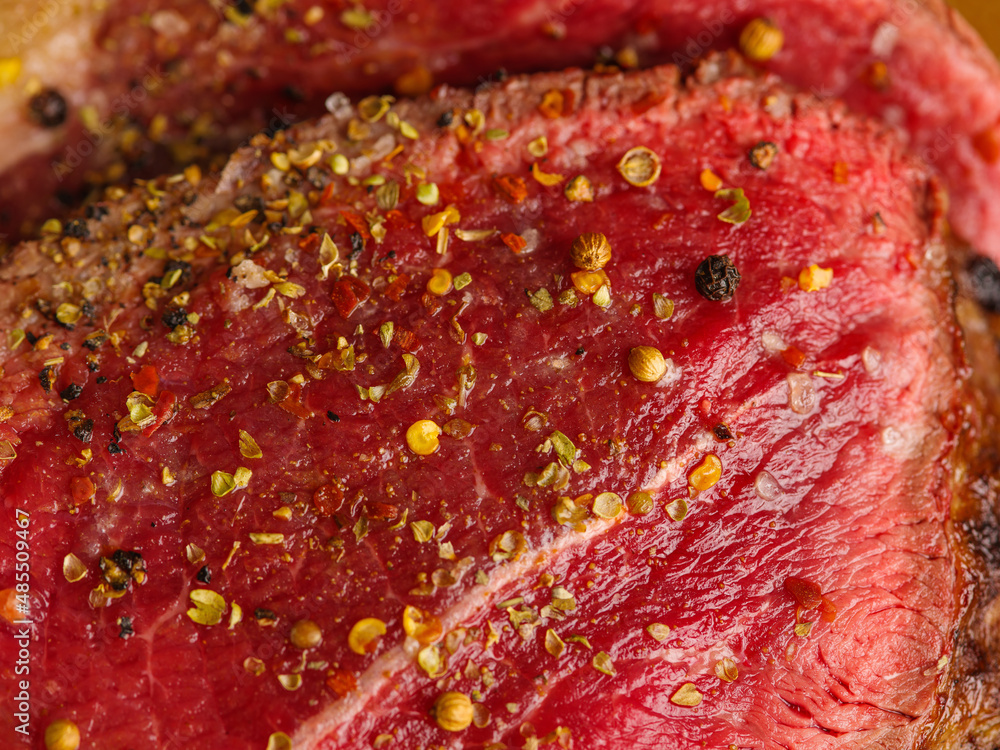 macro photography. A large piece of beef, pork, sprinkled with spices and seasonings. Cooking meat dishes - steaks, ham, boiled pork, grilled meat. Supermarket, farm. advertising, recipes. macro photography. A large piece of beef, pork, sprinkled with spices and seasonings. Cooking meat dishes - steaks, ham, boiled pork, grilled meat. Supermarket, farm. advertising, recipes.