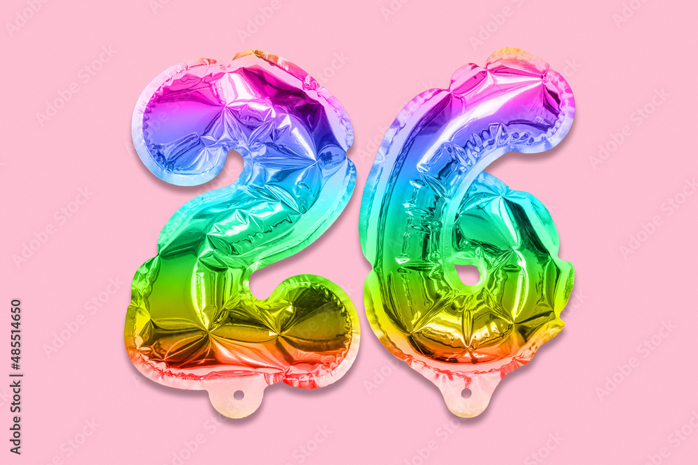 Rainbow foil balloon number, digit twenty six on a pink background. Birthday greeting card with inscription 26. Top view. Numerical digit. Celebration event, template. Rainbow foil balloon number, digit twenty six on a pink background. Birthday greeting card with inscription 26. Top view. Numerical digit. Celebration event, template.