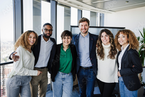 Multi-ethnic business colleagues standing together in office