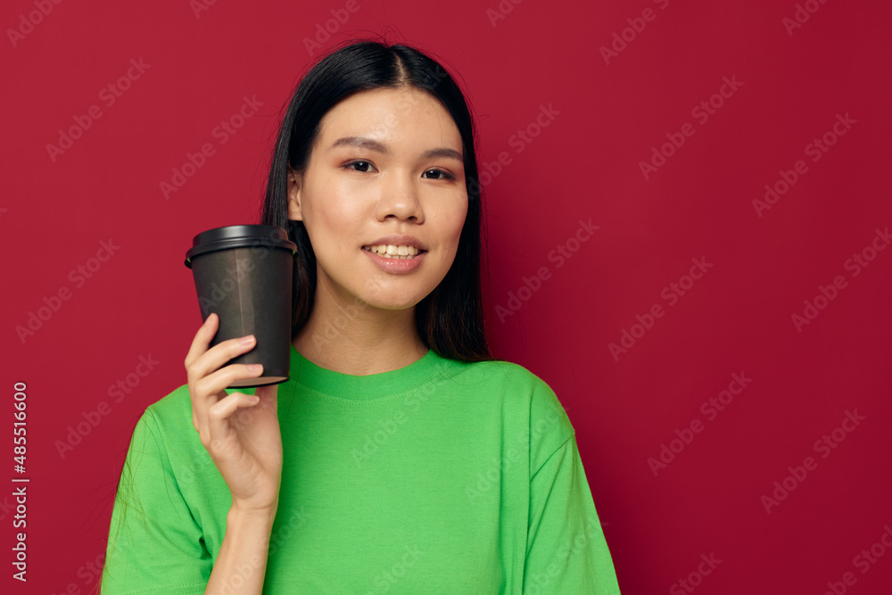 woman posing in a green t-shirt disposable black glasses red background unaltered woman posing in a green t-shirt disposable black glasses red background unaltered