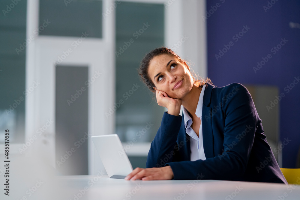 Businesswoman with tablet PC day dreaming at office Businesswoman with tablet PC day dreaming at office