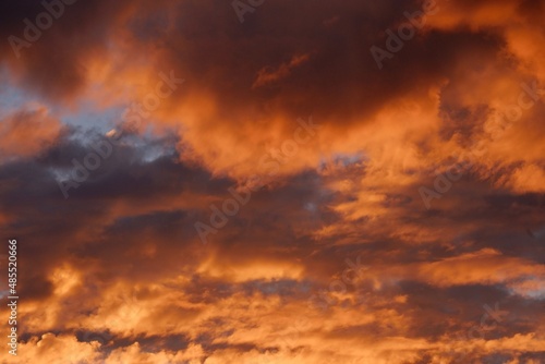 Blurred a group of dark clouds before rain with orange sky color